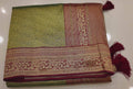 Regal Green and Maroon Saree with Intricate Floral Motifs",