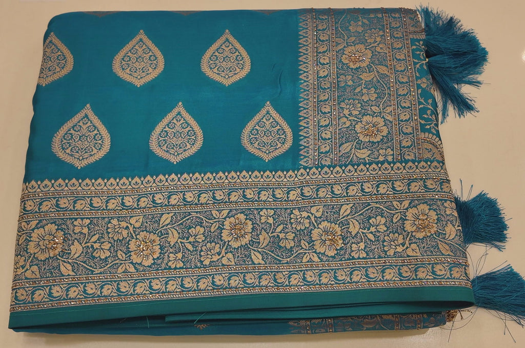 Peacock Charm: Vibrant Teal Saree with Gold Blossom Splendor",