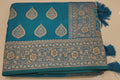 Peacock Charm: Vibrant Teal Saree with Gold Blossom Splendor",