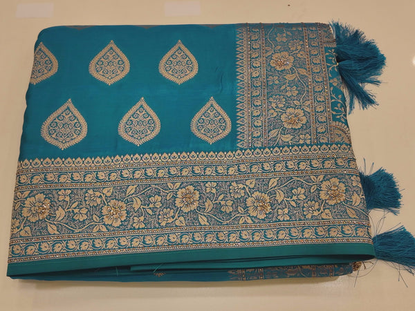Peacock Charm: Vibrant Teal Saree with Gold Blossom Splendor",