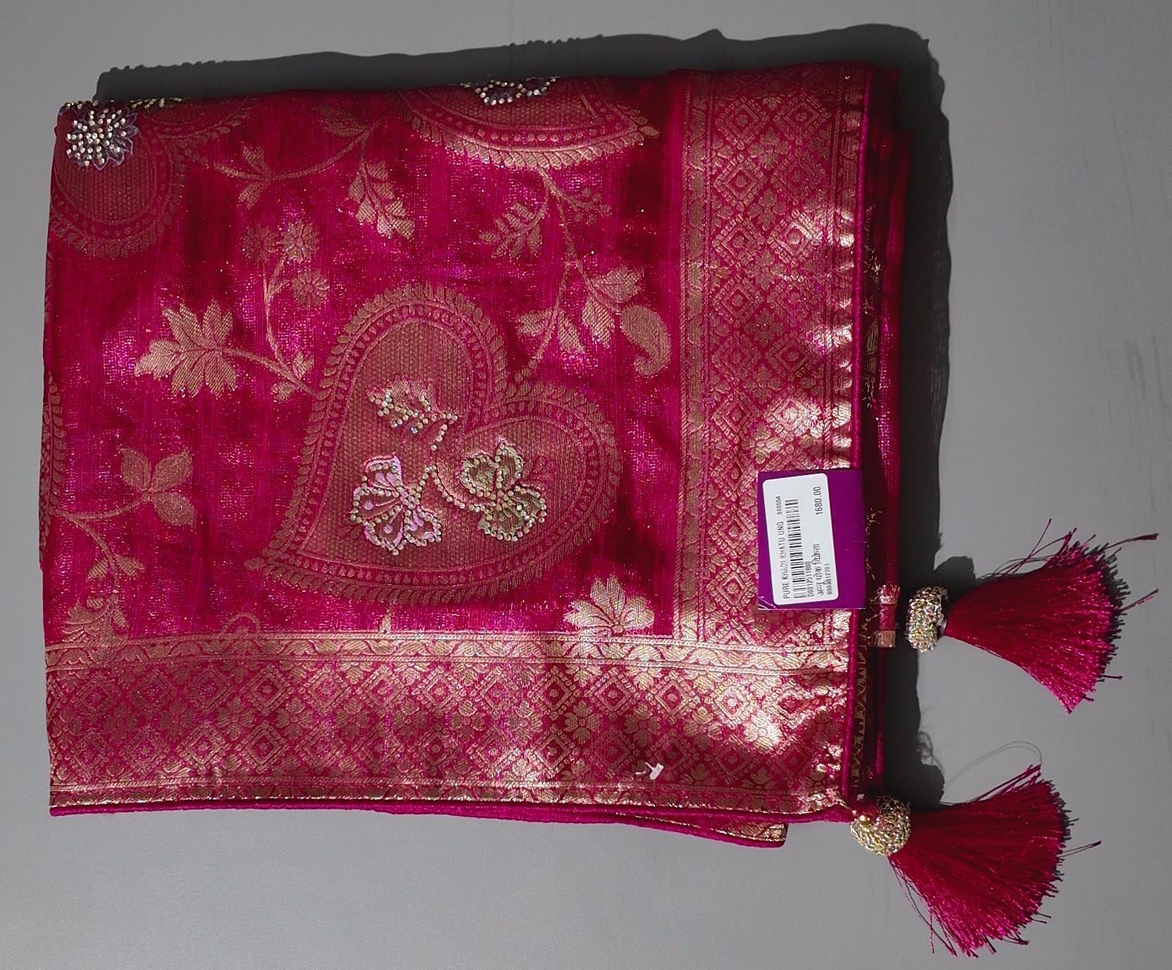 Opulent Ruby Red Saree with Intricate Golden Embroidery",