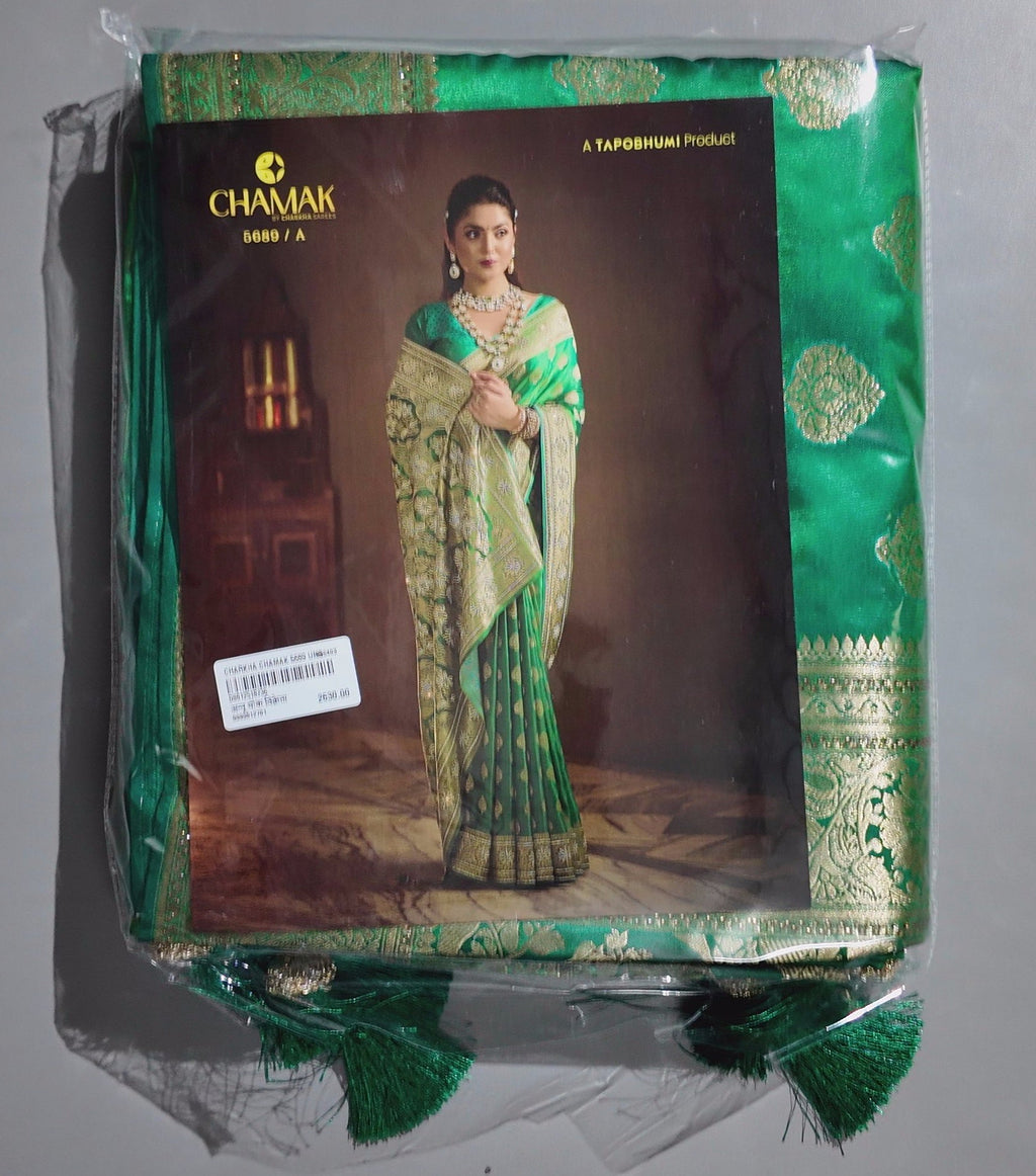 Emerald Enchantment: Traditional Green Saree with Opulent Gold Detailing",