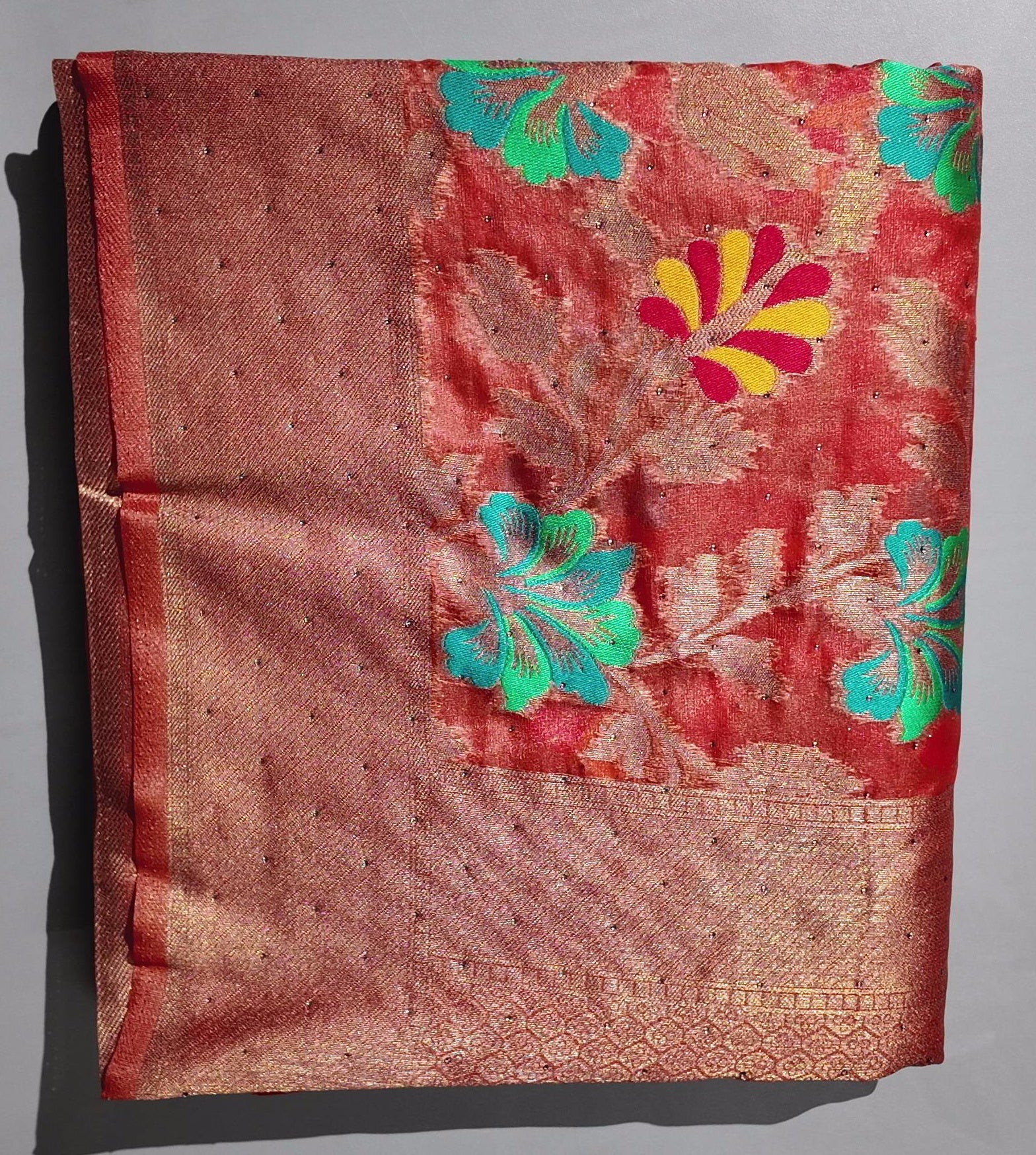 Radiant Rust Floral Saree with Intricate Green Accents",