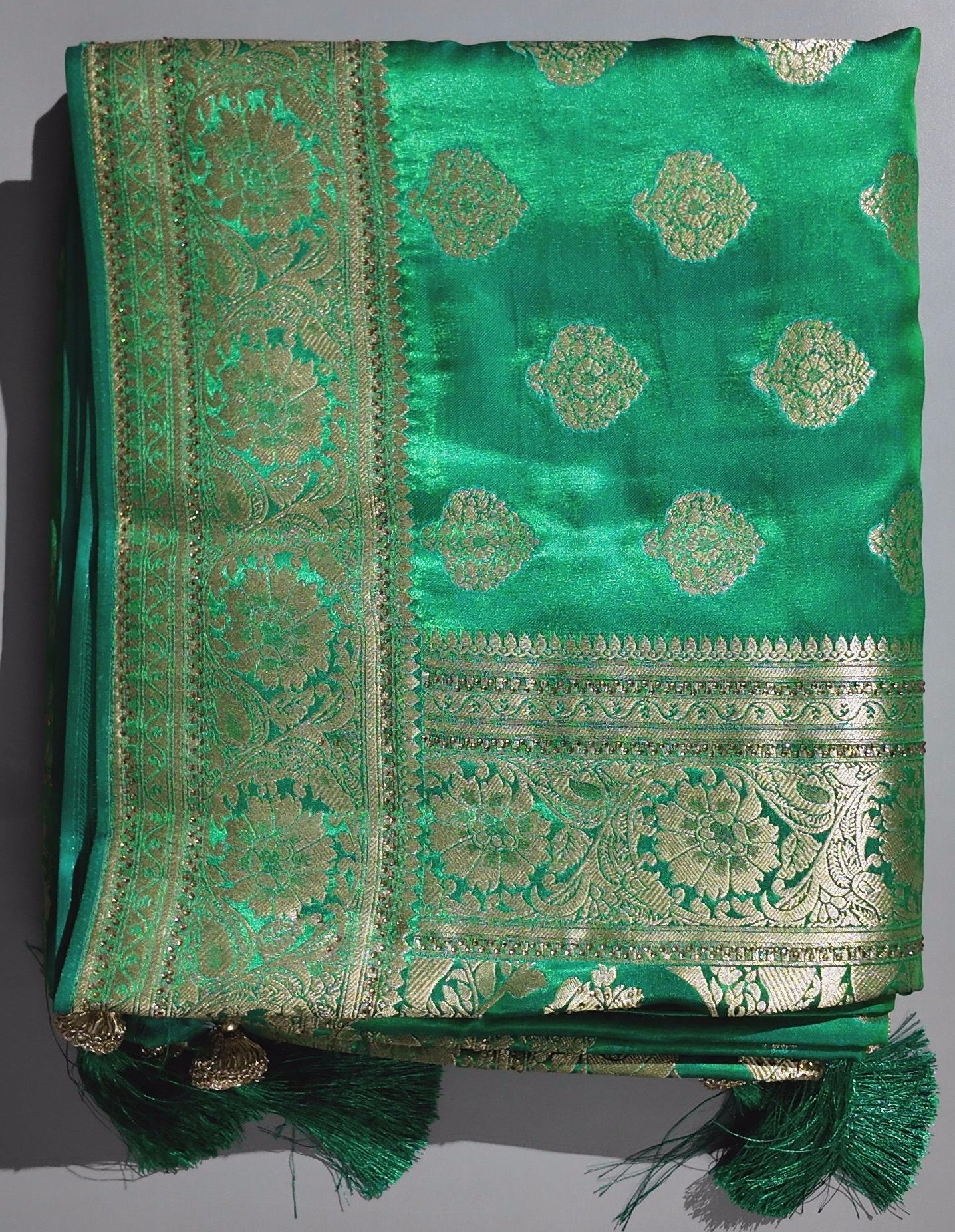 Emerald Enchantment: Traditional Green Saree with Opulent Gold Detailing",